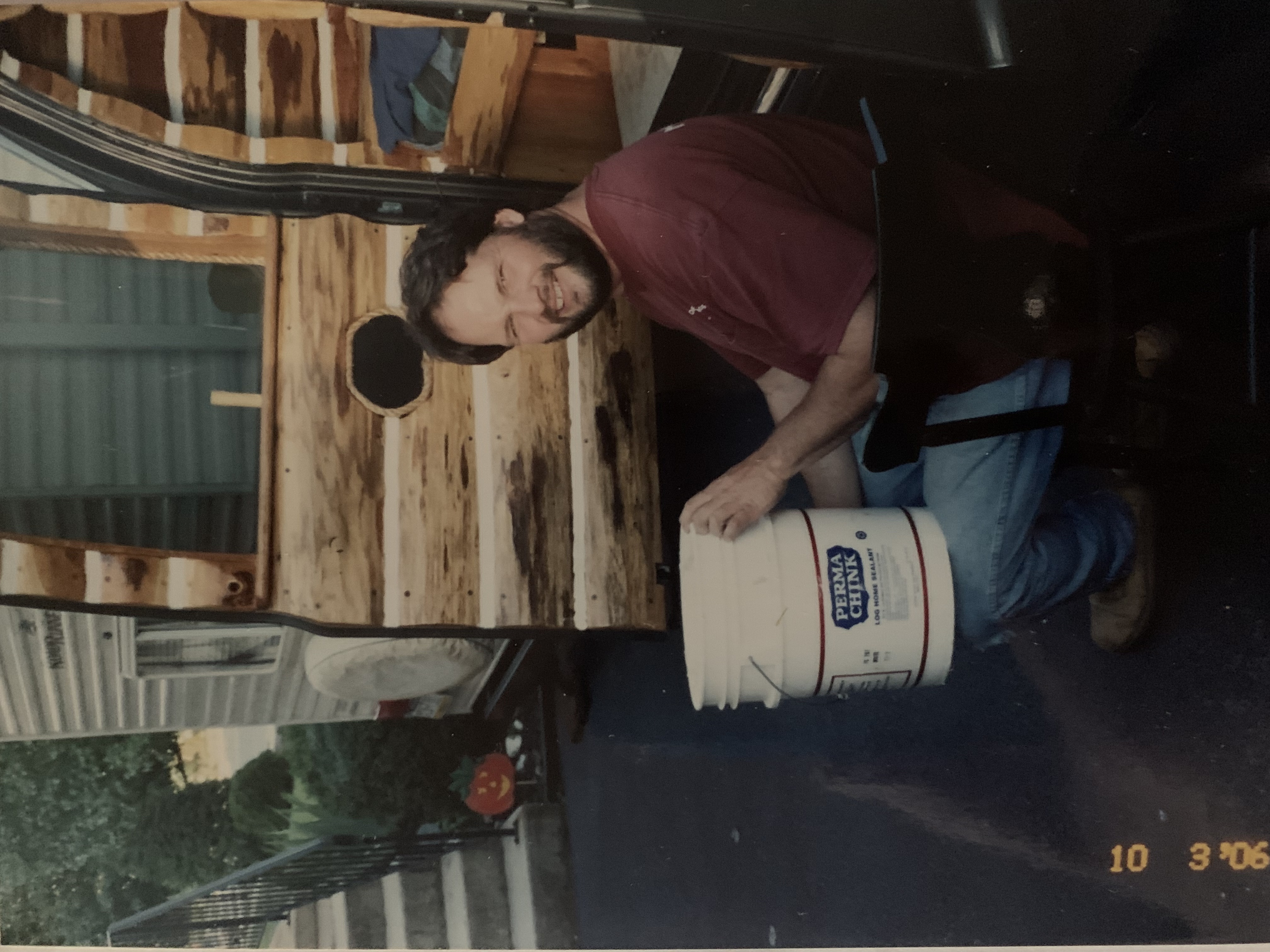 Shawn holding Perma-Chink bucket
